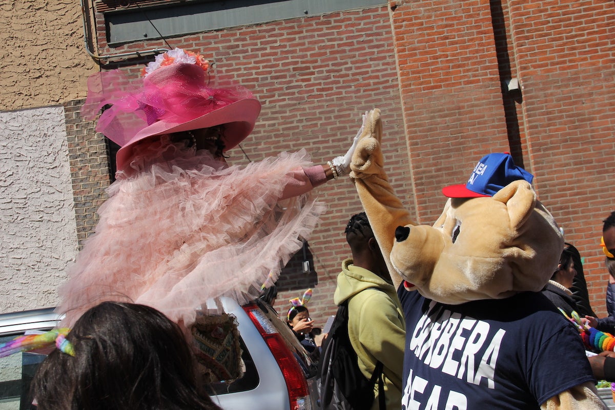 Mafalda Thomas-Bouzy high-fives Barbera Bear ahead of the South Street Easter Promenade