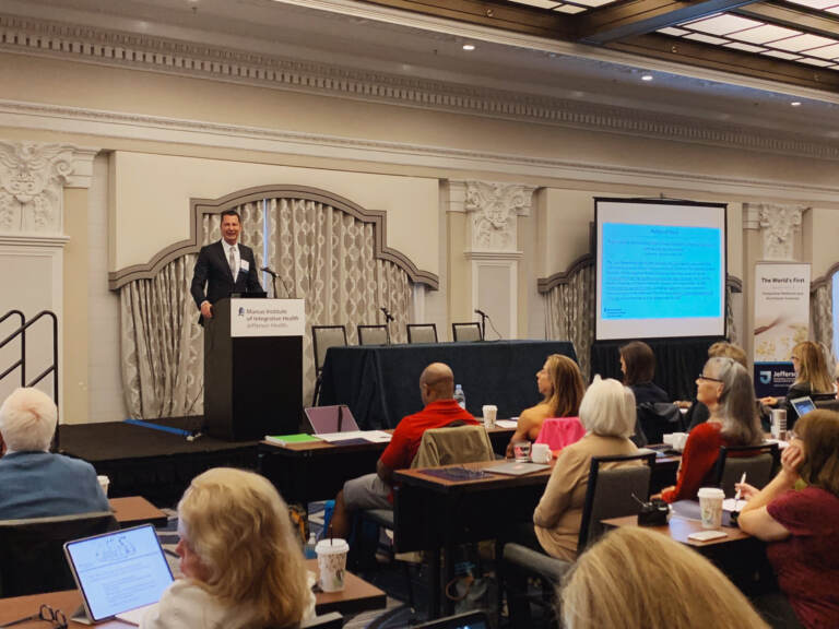 A person from March Institue of Integrative Health at Jefferson Health speaking to a group of people on stage