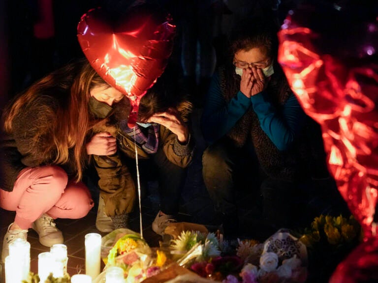 Woman honoring the victims of a shooting at the Star Ballroom Dance Studio