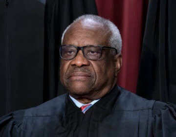 Associate Justice Clarence Thomas joins other members of the Supreme Court as they pose for a new group portrait, at the Supreme Court building in Washington