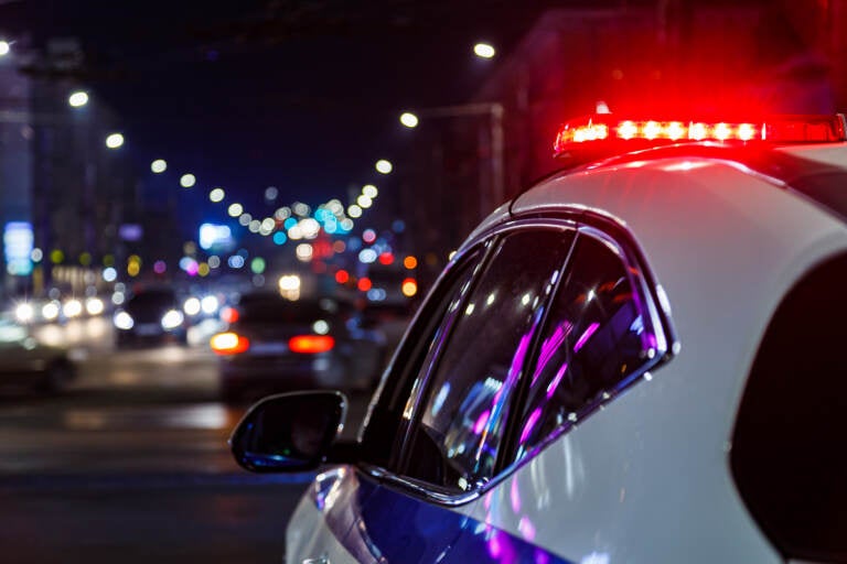 Police car with siren flashing.