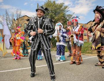 Members of the Philadelphia String Band Association, dressed in elaborate costumes, strut in Haddon Township