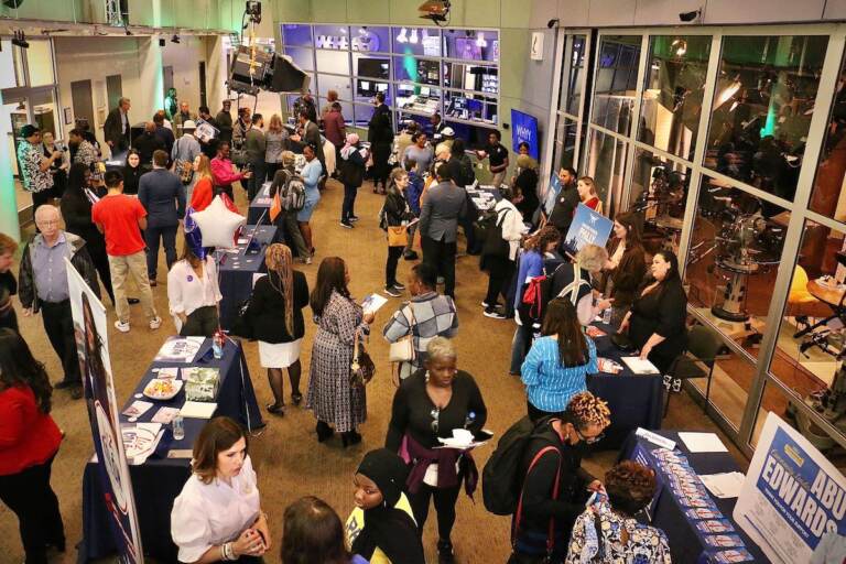 An aerial view of a crowd of people gathered in the lobby of WHYY News headquarters.