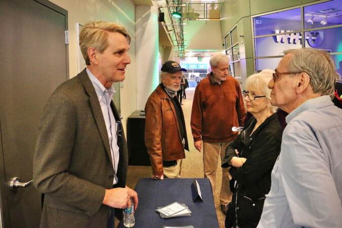 Philadelphia City Council candidate John B. Kelly (left) talks with voters at a candidate convention hosted by WHYY. (Emma Lee/WHYY)