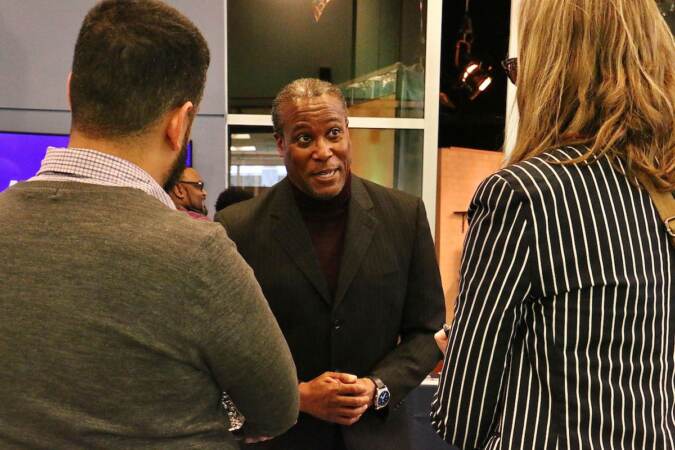 Philadelphia City Council candidate Clayton Prince talks with voters at a candidate convention hosted by WHYY. (Emma Lee/WHYY)