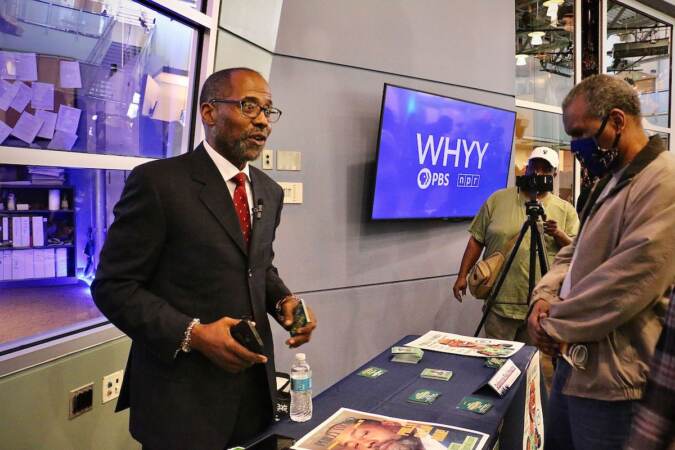 Philadelphia City Council candidate Ogbonna Paul Hagins (left) talks with voters at a candidate convention hosted by WHYY. (Emma Lee/WHYY)