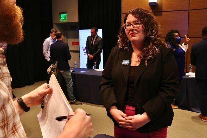 Philadelphia City Council candidate Amanda McIlmurray talks with voters at a candidate convention hosted by WHYY. (Emma Lee/WHYY)