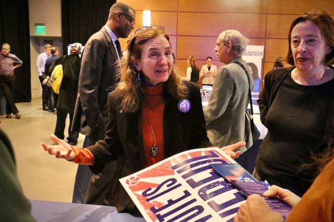 Philadelphia City Council candidate Sherrie Cohen talks with voters at a candidate convention hosted by WHYY. (Emma Lee/WHYY)