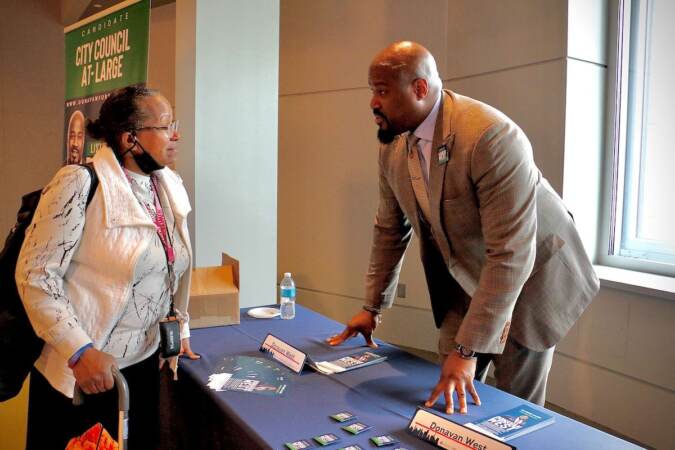 Philadelphia City Council candidate Donovan West talks with voters at a candidate convention hosted by WHYY. (Emma Lee/WHYY)