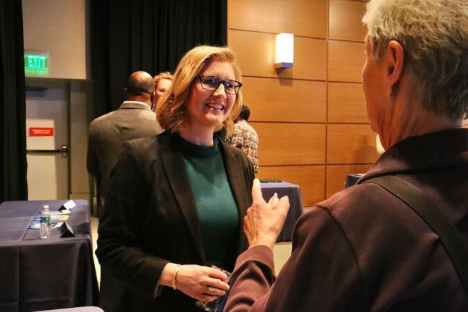 Philadelphia City Council candidate Eryn Santamoor talks with voters at a candidate convention hosted by WHYY. (Emma Lee/WHYY)