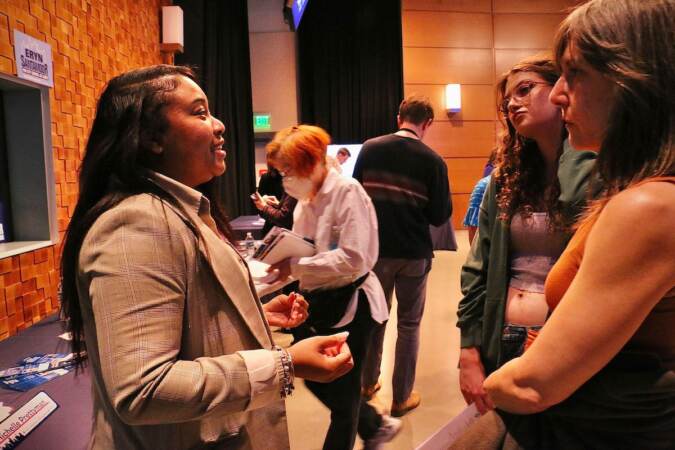 Philadelphia City Council candidate Michelle Prettyman (left) talks with voters at a candidate convention hosted by WHYY. (Emma Lee/WHYY)