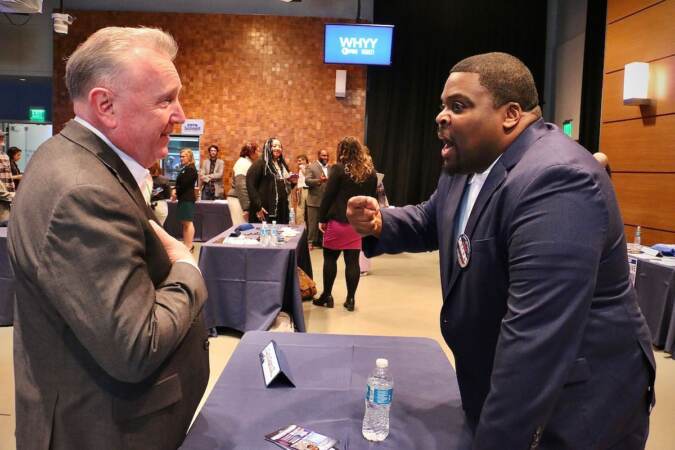 Philadelphia City Council candidate Curtis Segers III (right) talks with voters at a candidate convention hosted by WHYY. (Emma Lee/WHYY)