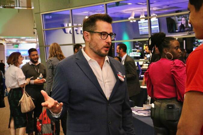 Philadelphia City Council candidate Drew Murray talks with voters at a candidate convention hosted by WHYY. (Emma Lee/WHYY)