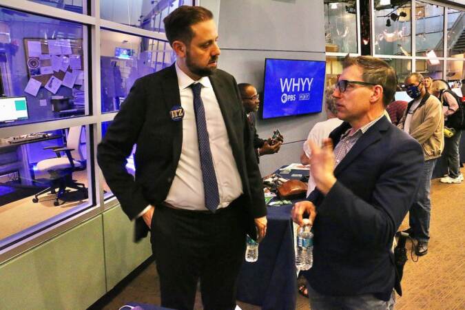 Philadelphia City Council candidate Job Itzkowitz (left) talks with voters at a candidate convention hosted by WHYY. (Emma Lee/WHYY)