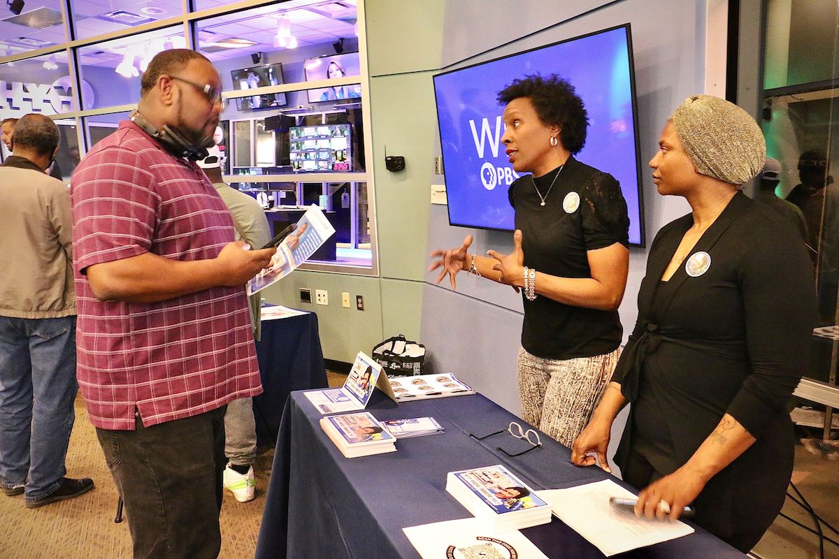 Philadelphia City Council candidate Qiana Shedrick (center) talks with voters at a candidate convention hosted by WHYY. (Emma Lee/WHYY)