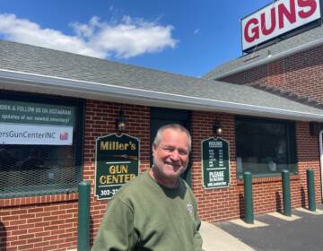 Bob Mineo poses outside of Miller's Gun Center.