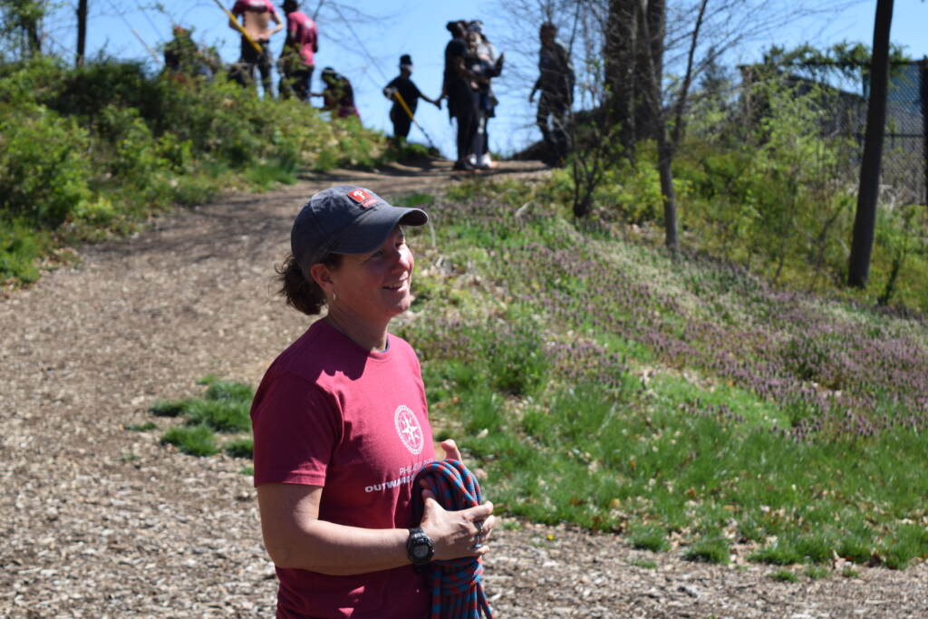 A woman is standing outside in a park.