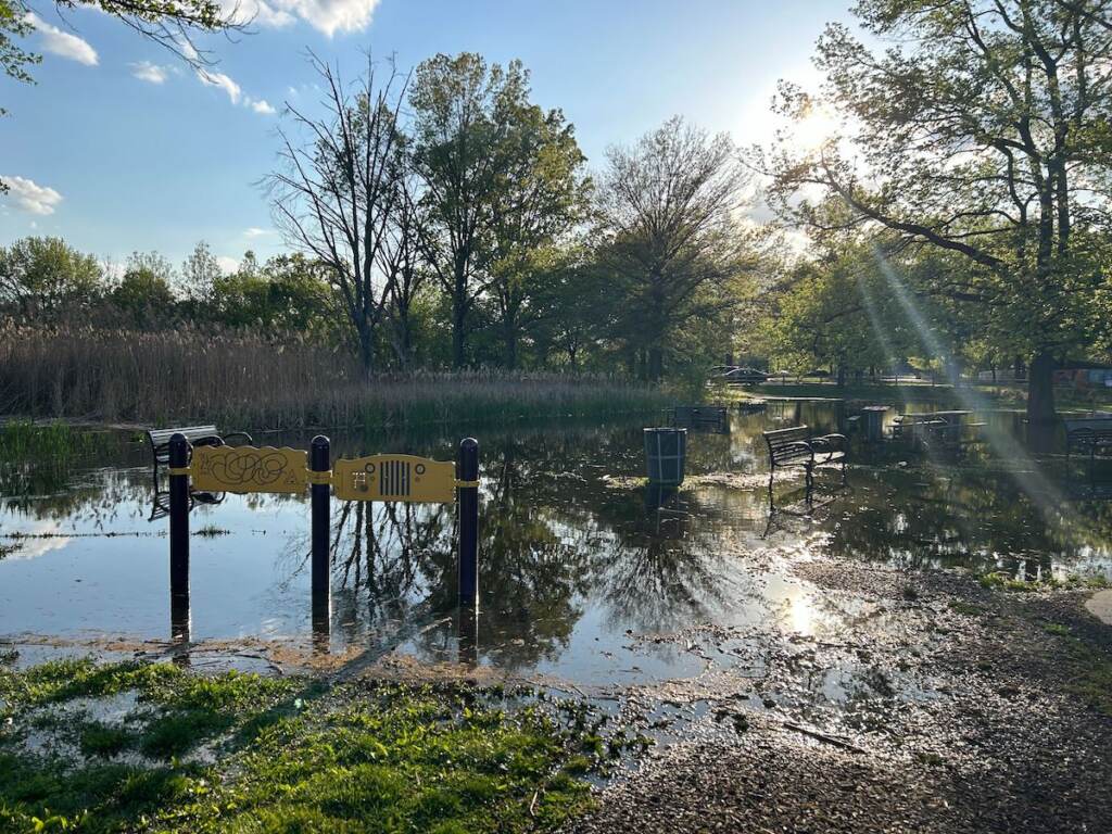 Flooding extends to a walking path and benches.