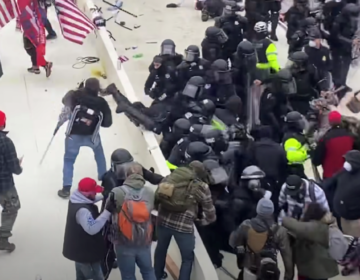 YouTube footage cited in an FBI document reportedly captures Sanford, bottom left, as he hurls an object at Capitol Police. (Youtube)