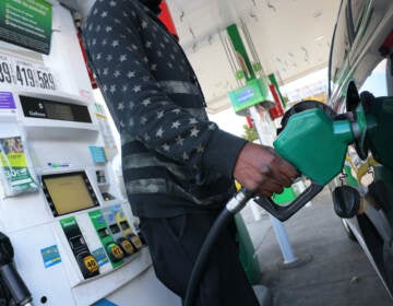 person prepares to pump gas at a BP gas station