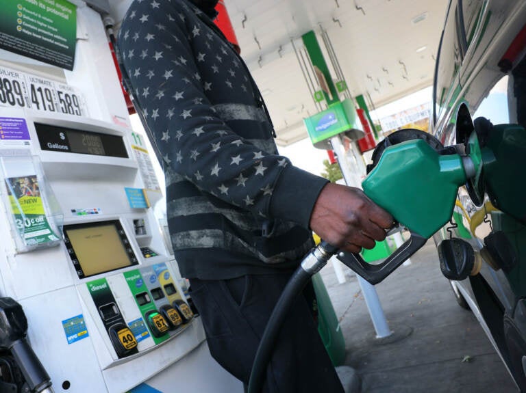 person prepares to pump gas at a BP gas station