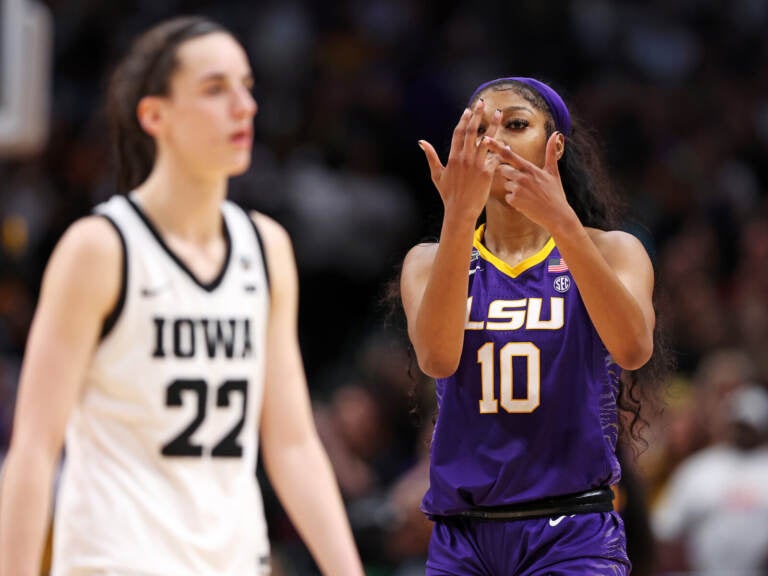 Angel Reese of the LSU Tigers gestures towards Caitlin Clark of the Iowa Hawkeyes towards the end of the NCAA Women's Basketball Tournament championship game in Dallas