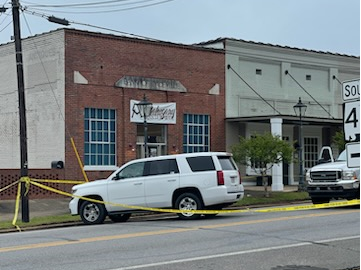 Police tape is seen outside the scene of a shooting in the city of Dadeville, Ala., that left at least four people dead and multiple others wounded