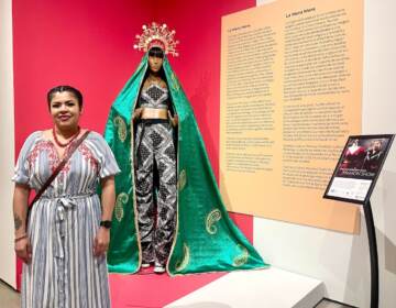 Julieta Zavala poses with one of her designs currently on display at the Delaware Art Museum.