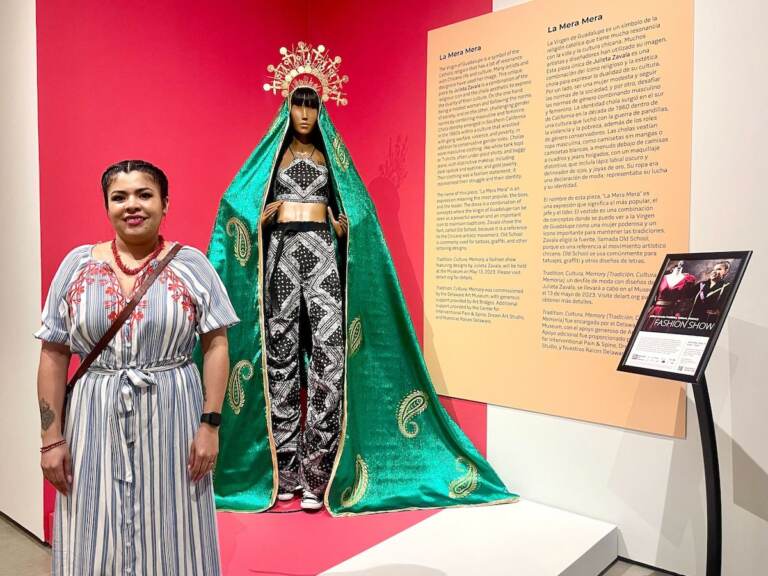Julieta Zavala poses with one of her designs currently on display at the Delaware Art Museum.
