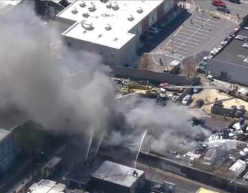 An aerial view of a junkyard fire.