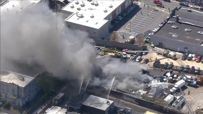 An aerial view of a junkyard fire.