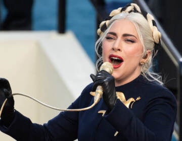 Lady Gaga sings into a microphone.