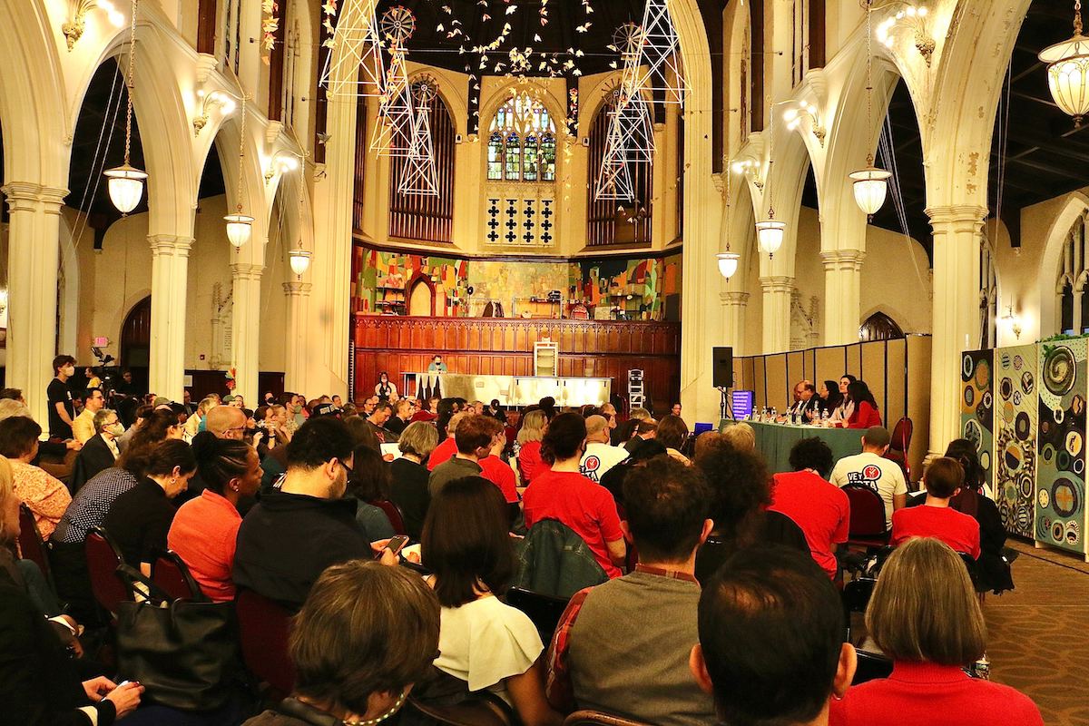 An audience fills a large church space.