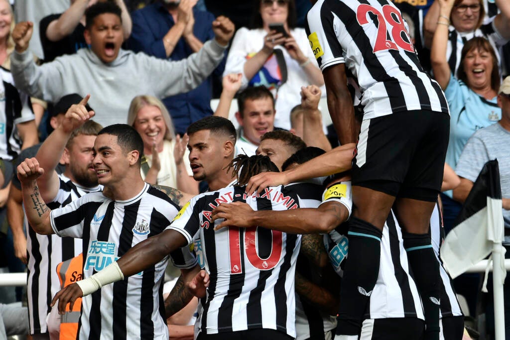 Soccer team celebrating a goal.