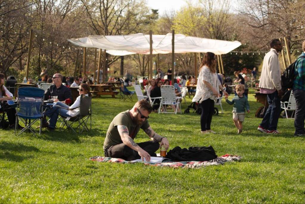 People sit and stroll in a park.