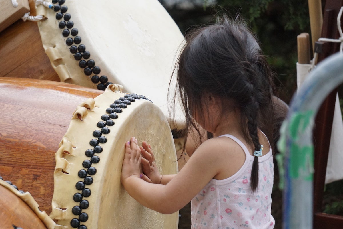 A child plays with a taiko drum