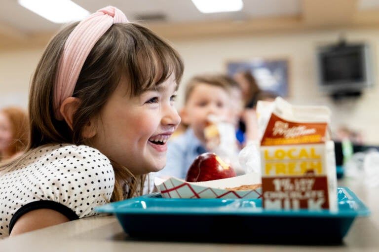 Young girl eating lunch in school cafeteria