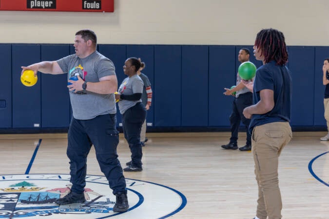 7th and 8th graders from Mastery Melina Upper School play dodge ball with Camden County police officers at the 10th anniversary event for the Camden County Police Department on May 1, 2023. (Kimberly Paynter/WHYY)