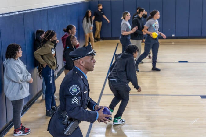 7th and 8th graders from Mastery Melina Upper School play dodge ball with Camden County police officers at the 10th anniversary event for the Camden County Police Department on May 1, 2023. (Kimberly Paynter/WHYY)