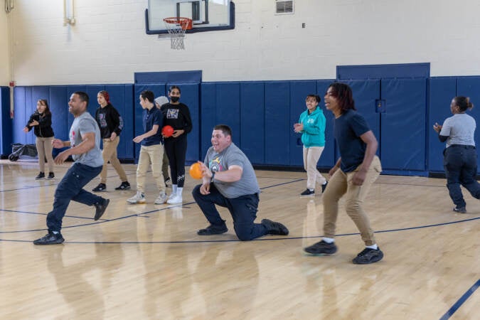 7th and 8th graders from Mastery Molina Upper School play dodge ball with Camden County police officers at the 10th anniversary event for the Camden County Police Department on May 1, 2023. (Kimberly Paynter/WHYY)