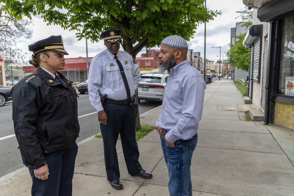 Bobbie Ridgeway, owner of a barbershop on Ridge Avenue since 2013 (right) questions Philadelphia Police Commissioner Danielle Outlaw (left) and 22nd District Captain Michael Goodson (center) about violence in the neighborhood.