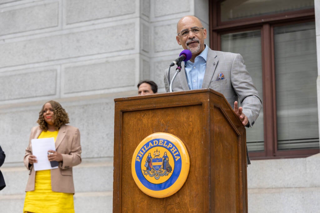 Chris Rabb speaks at a podium.