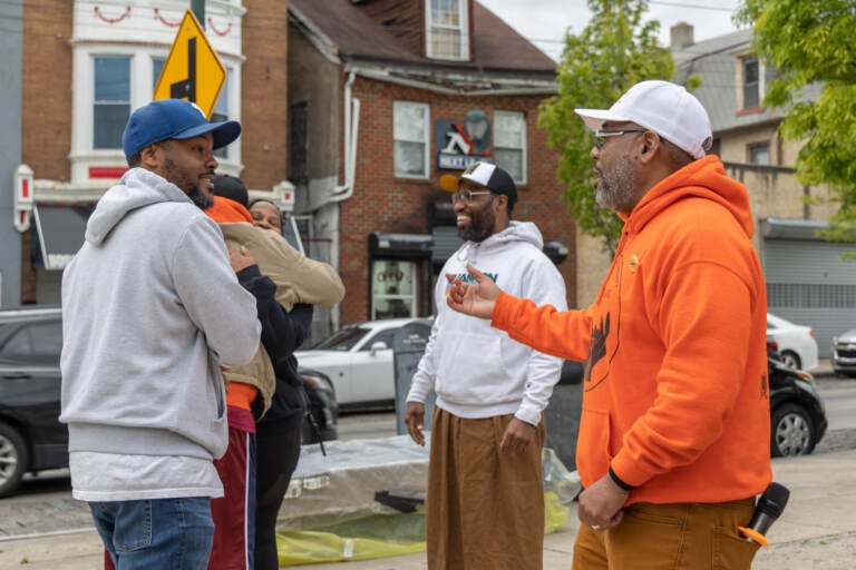 Joe Budd talking with members of the community at a block party.