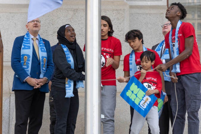 Kids from the Starfinder soccer club in Philadelphia helped raised the FiFA World Cup 2026 flag at City Hall on May 18, 2023. (Kimberly Paynter/WHYY)