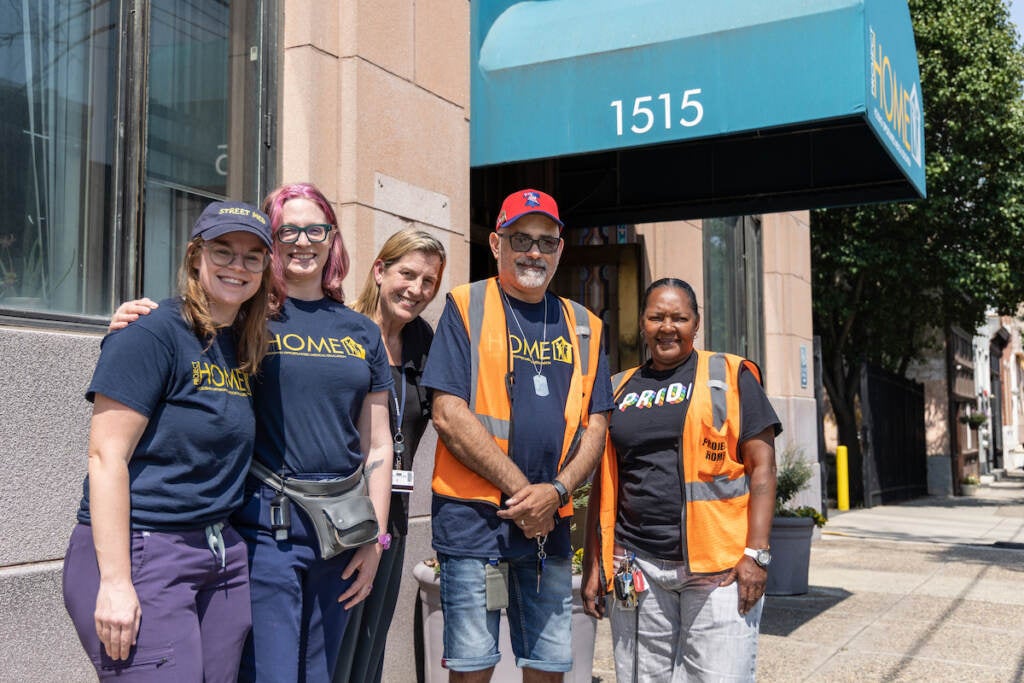 Project Home medical street team RN Hillary Miller (left), associate director of the medical street team Kara Cohen (second from left), specialist outreach workers Sam Santiago (second from right) and Monique Taylor (right) all work with medical director Dr. Laura Carson Weinstein (center) stand outside of a building, posing for a photo.