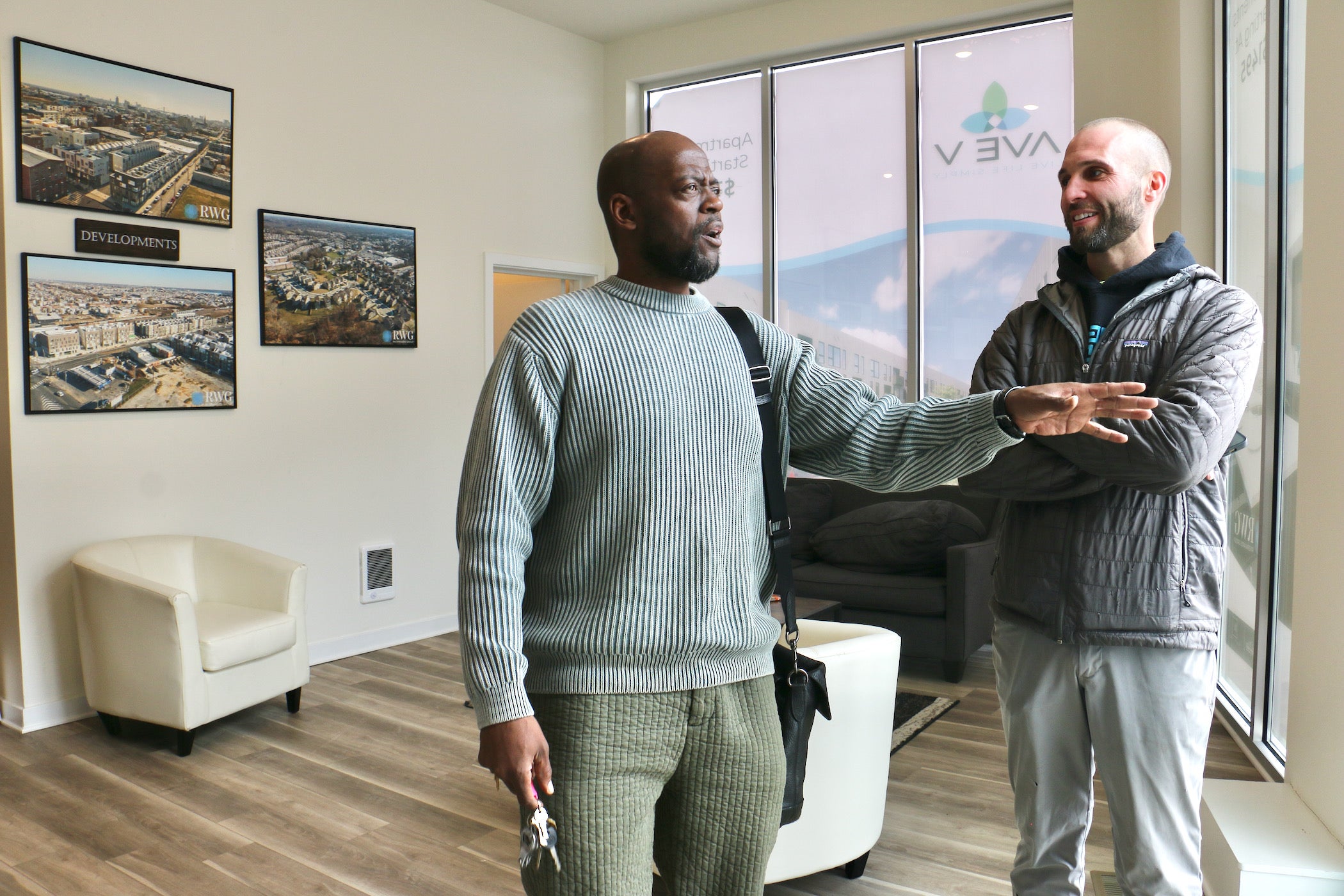 Dawud Bey talks with Chadwick Smith in an office.