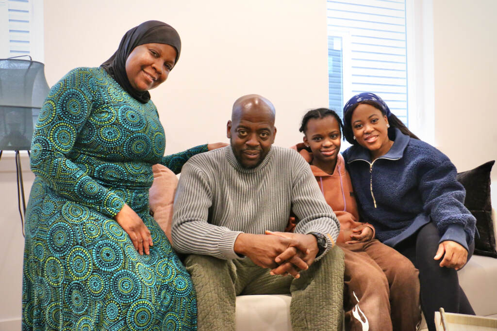 Dawud Bey poses for a photo with family, including wife Tabetha Fulton Bey, granddaughter Sahiyah Cooper, and daughter Shaakira Bey Berryman.