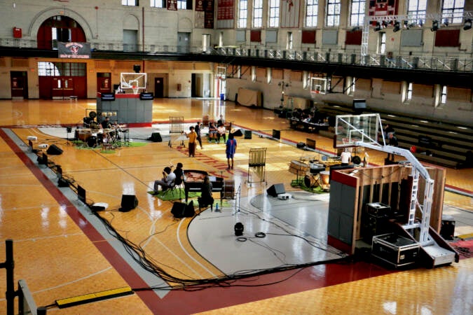 An aerial view of performers at work in a gymnasium.
