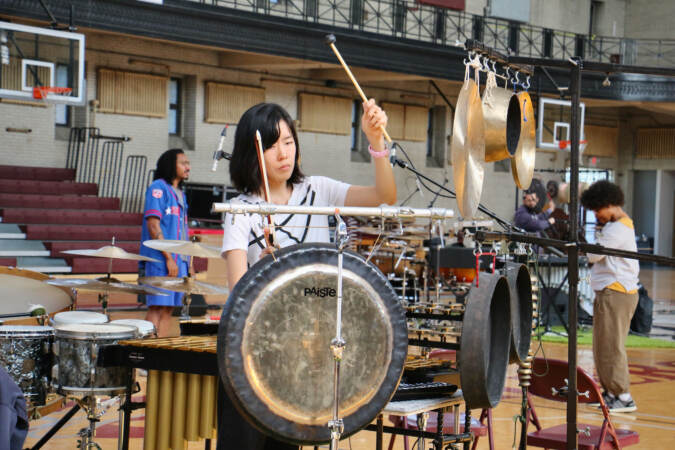 A performer plays a drum set.