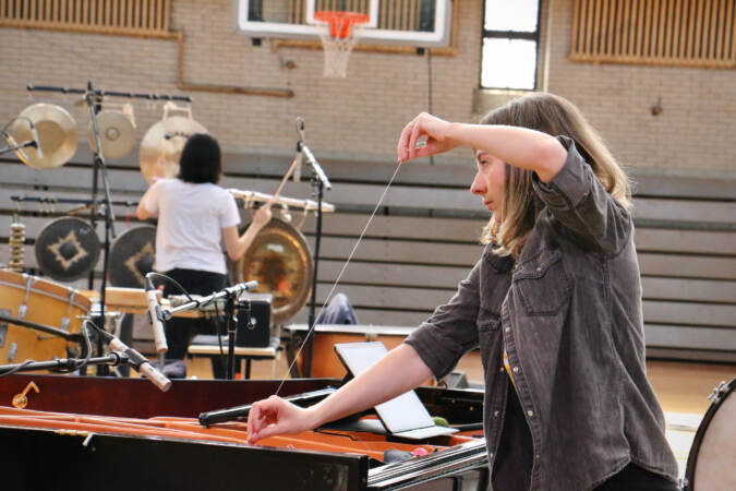 A performer holds a piece of string.